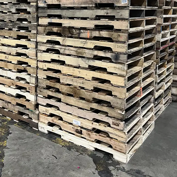 stacks of wood pallets in warehouse